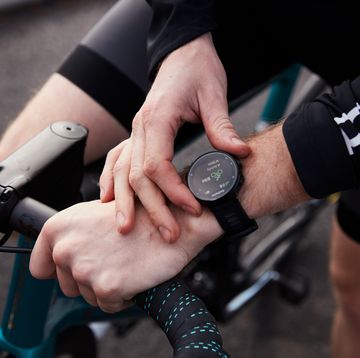 a cyclist starts a garmin watch before a ride