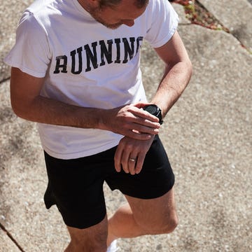 runner checking garmin watch runner checking garmin watch