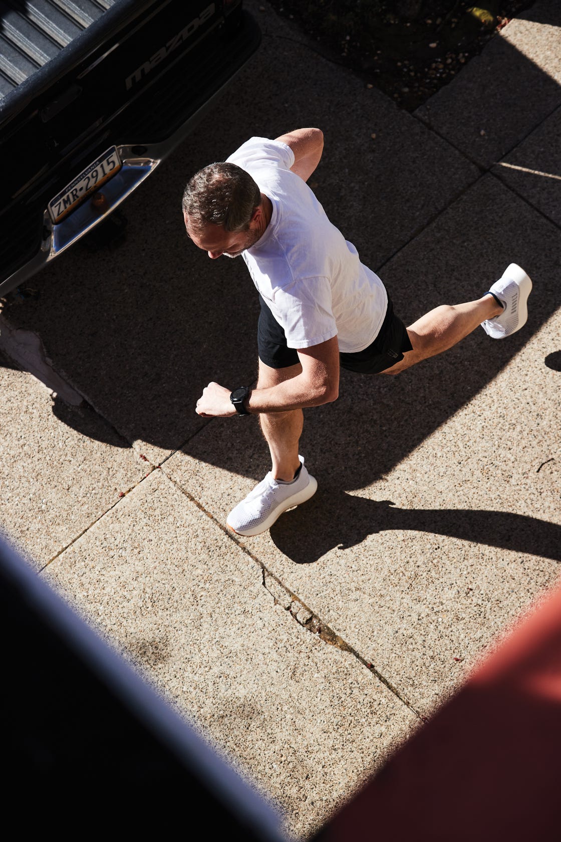 man running with garmin smartwatch