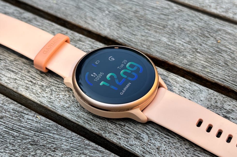 close up of a pink smartwatch with a colourful display