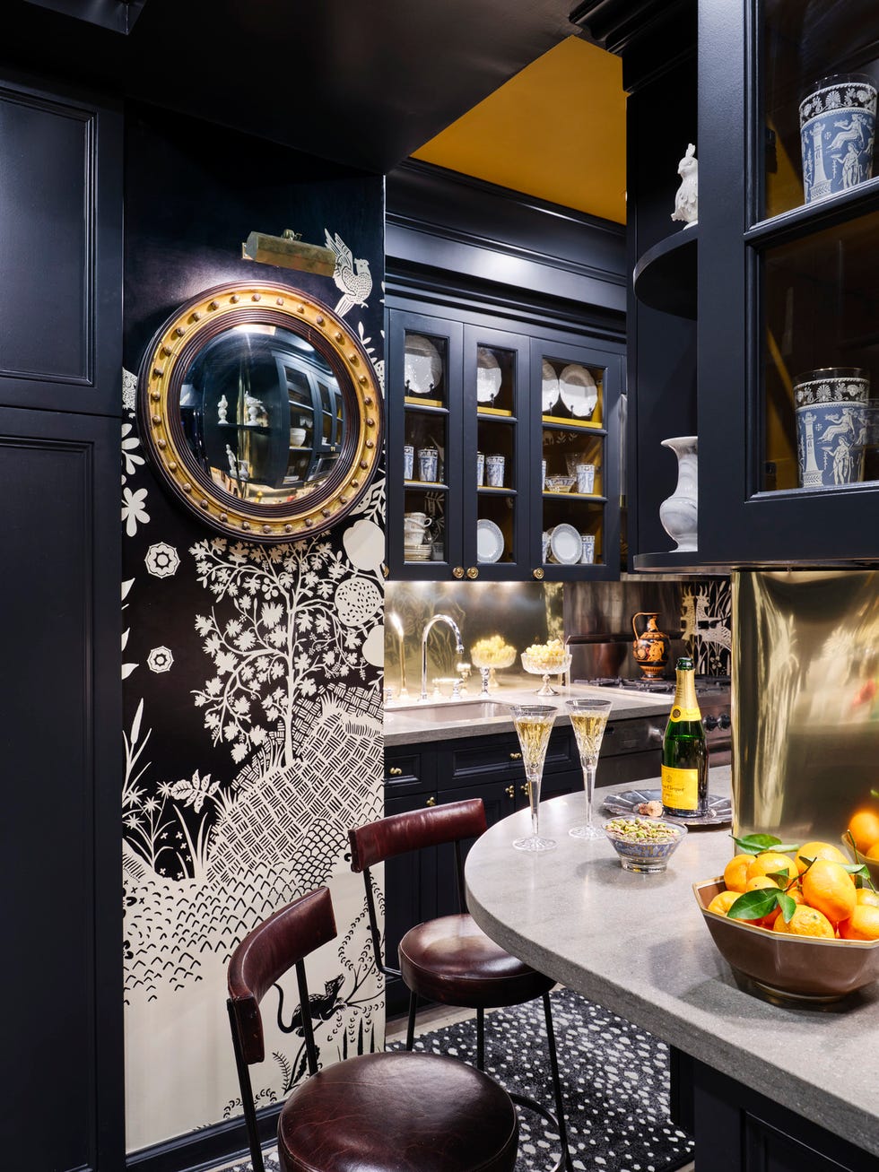 a 19th century butler mirror offers a peek into the kitchen and its brass sheet backsplash