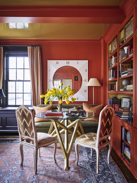 the plentiful south and east facing light of this former bedroom inspired him to turn it into his study and cloak it in seductive red