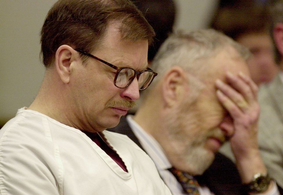 green river killer gary ridgway looking downward with his eyes closed as he sits in court