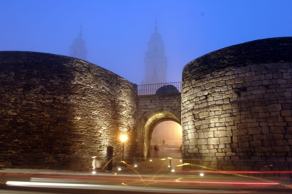 gate of santiago in the roman wall of lugo with the cathedral to the bottom the wall is the most impressive testimony left by the romans in galicia a city wall, two thousand years old, with a perimeter of little more thas 2 kilometers in 2001 it was d