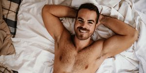 gay couple at home smiling man in bed