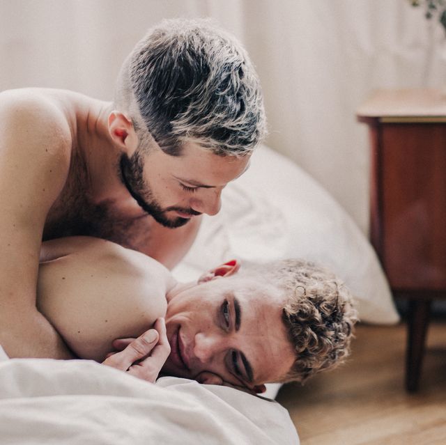 gay couple embracing in bed