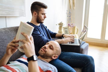 Gay Couple Enjoying Togetherness On Sofa