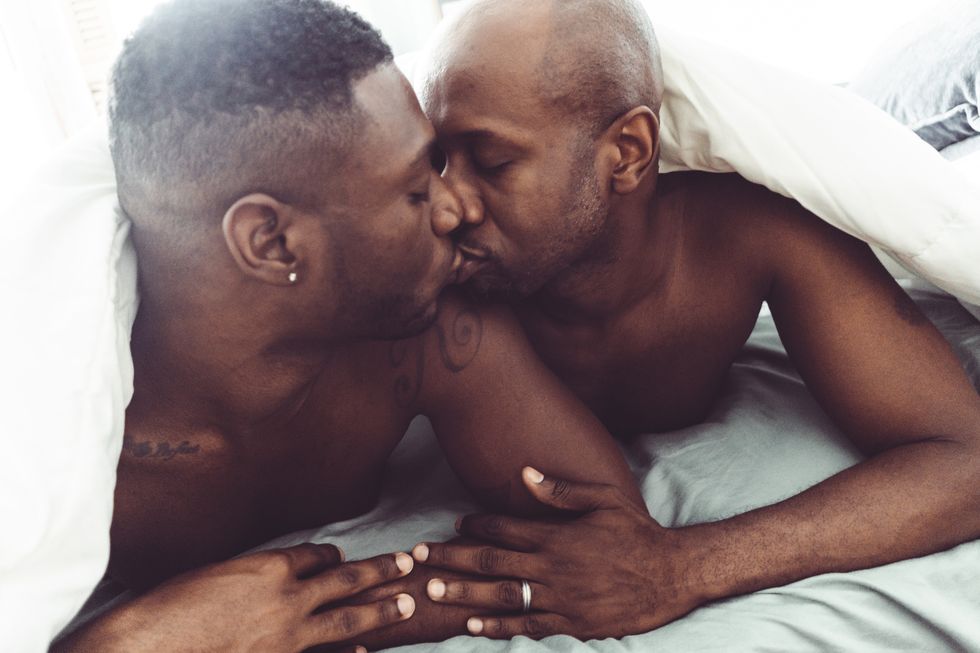 gay couple kissing and make sex in the bed