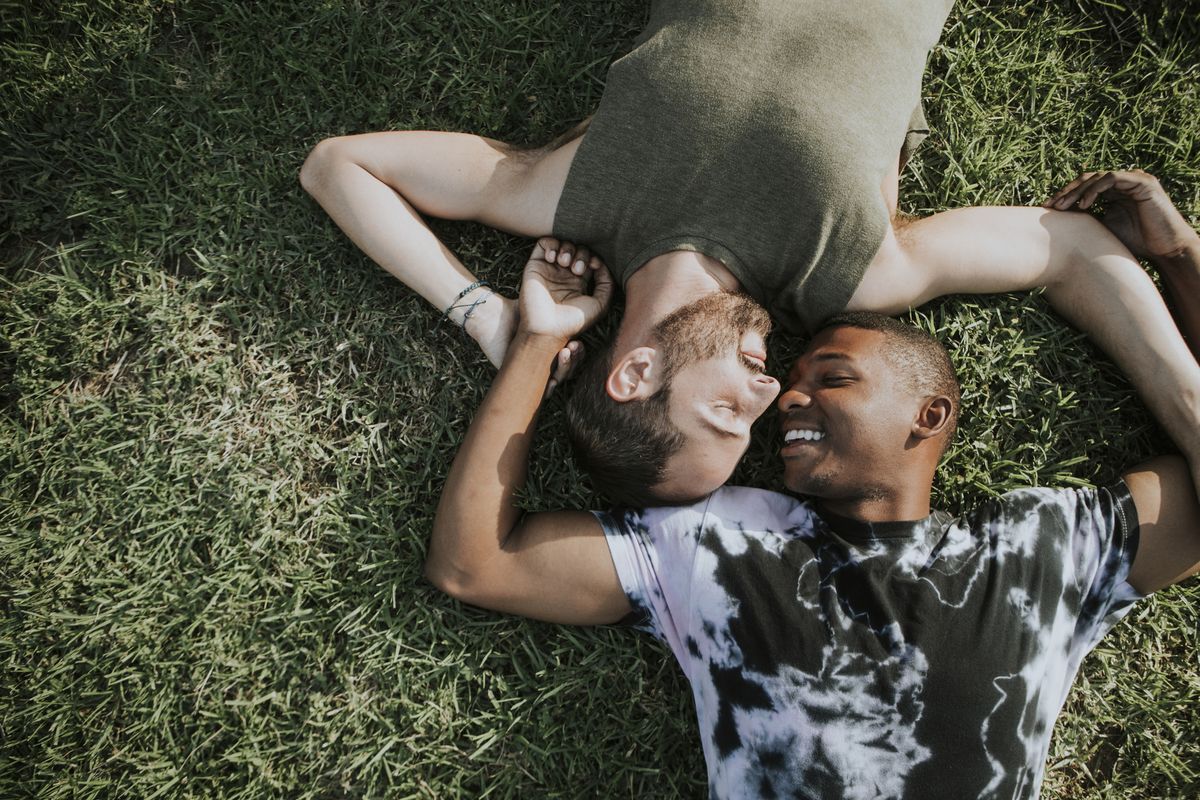 gay couple relaxing in the grass