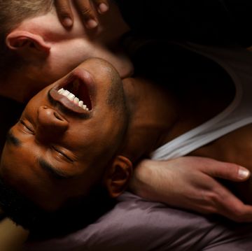 gay men kissing on sofa