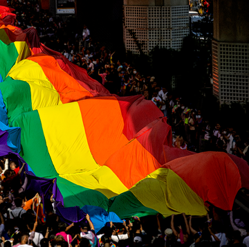 a crowd of people holding lgbtq pride flags