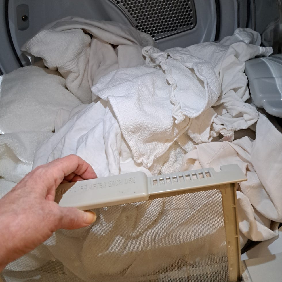 Best Clothes Dryer- GE Profile Smart Electric Dryer ge profile smart electric dryer with laundry inside and hand pulling out lint trap