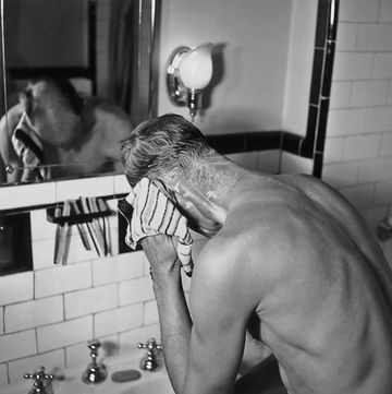 a man washing himself in front of a mirror at a wash basin, circa 1945 photo by herbertfrederic lewisarchive photosgetty images