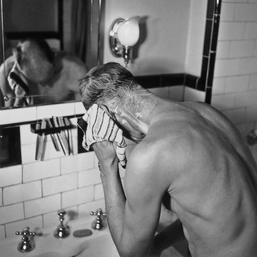 a man washing himself in front of a mirror at a wash basin, circa 1945 photo by herbertfrederic lewisarchive photosgetty images