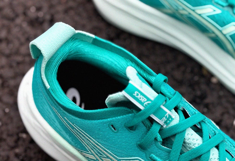 athletic shoe designed for running featuring a turquoise upper and white sole