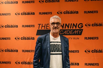 event backdrop featuring branding from the running academy and sponsors