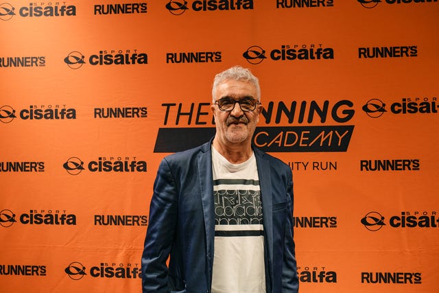 event backdrop featuring branding from the running academy and sponsors