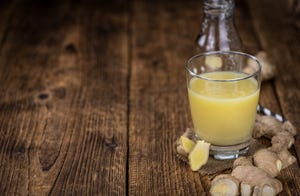 portion of fresh ginger juice selective focus close up shot