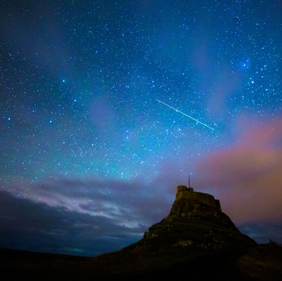 geminid meteor over lindisfarne castle on the holy island, nothumberland