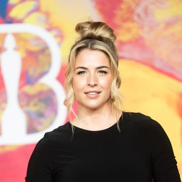 gemma atkinson wearing a black long sleeve dress and her hair in an up do