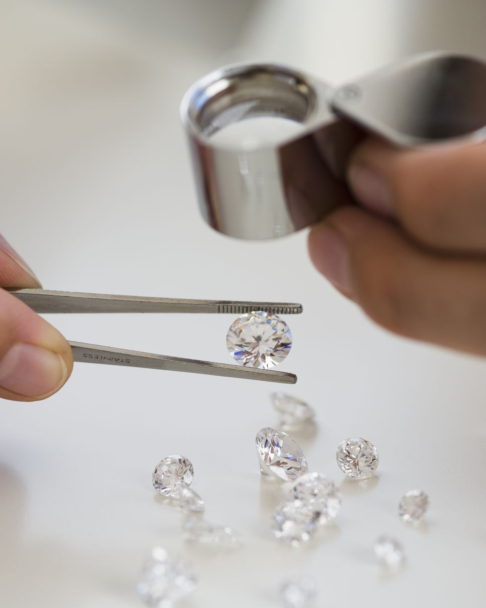 Gemologist inspecting diamonds using loupe