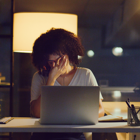 woman sat a laptop looking sad