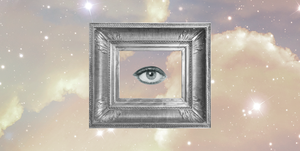 a single eye looks out from a silver picture frame