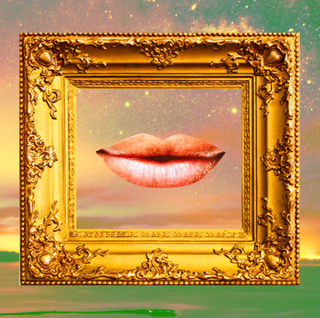 a slightly smiling mouth is framed inside a golden picture frame over a green and pink sky