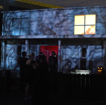 Guests enter a spooky house as part of Universal Studios' Halloween Horror Nights guests enter a spooky house as part of universal studios' halloween horror nights