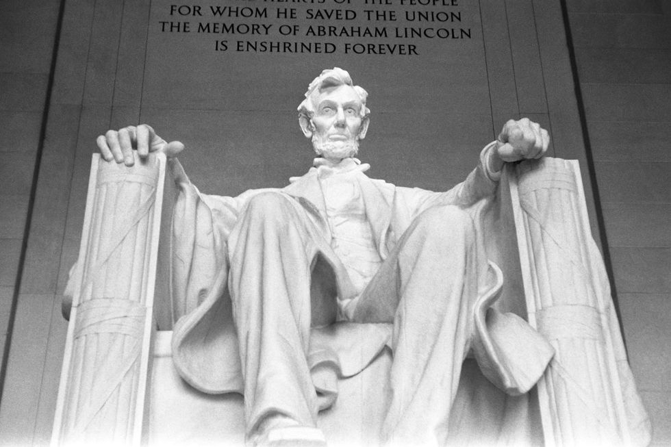 a large statue of abraham lincoln with an engraving behind it