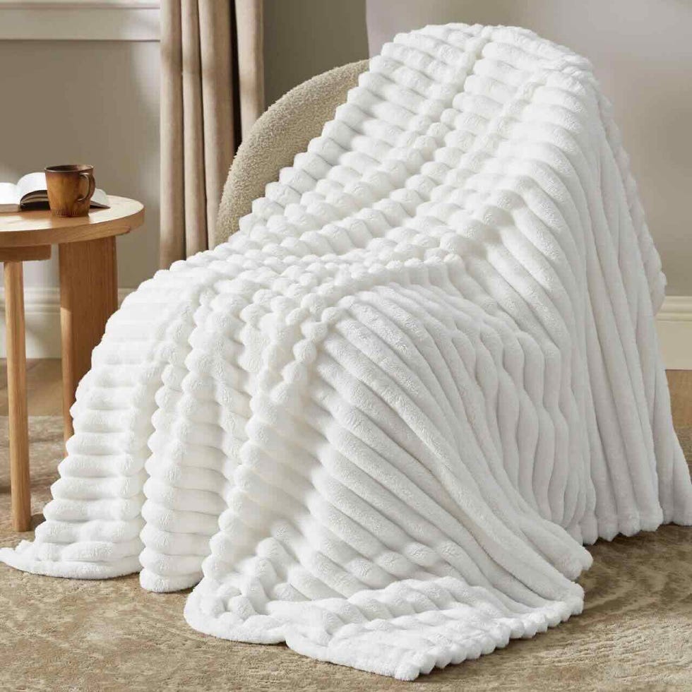 cozy white blanket draped over a chair