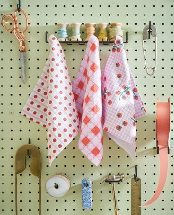 geometry dish towels designed by brittany watson jepsen hanging on peg board with craft supplies and tools