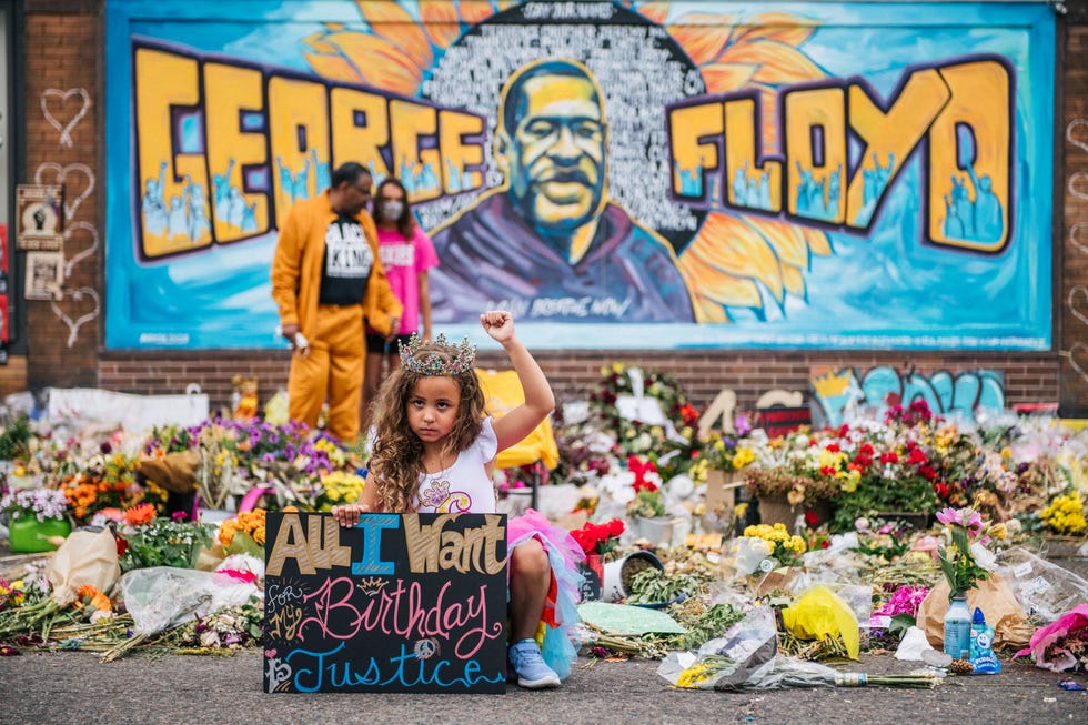 minneapolis, mn   june 9 a girl holds her fist in the air while visiting the memorial for george floyd on june 9, 2020 in minneapolis, minnesota residents of the community, and people around the world, have come together in calling for an end to police brutality after the death of george floyd, who was killed while in minneapolis police custody on may 25th  photo by brandon bellgetty images