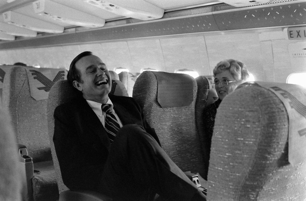 george h w bush sits with his wife, barbara bush, on an airplane, washington dc, october 1971