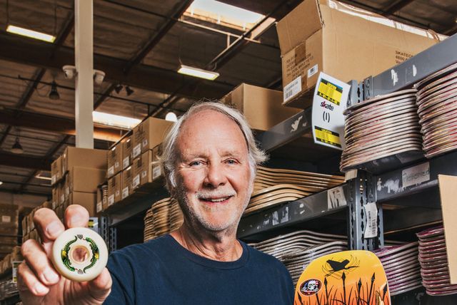 george powell holds a powell peralta dragon formula wheel and a bones brigade skateboard deck at the company’s factory in ventura, california