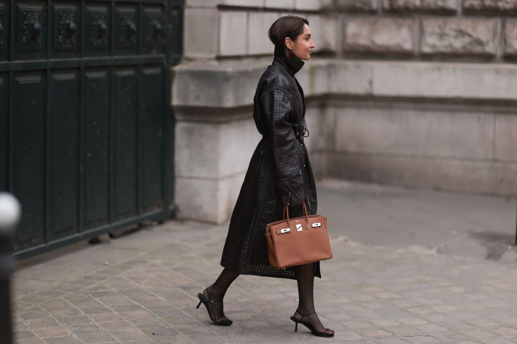 geraldine boublil wears a brown long jacket tan hermes bag news photo