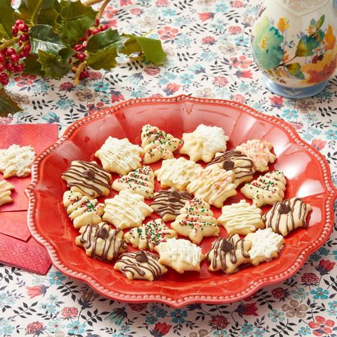 spritz cookies with different toppings on red plate