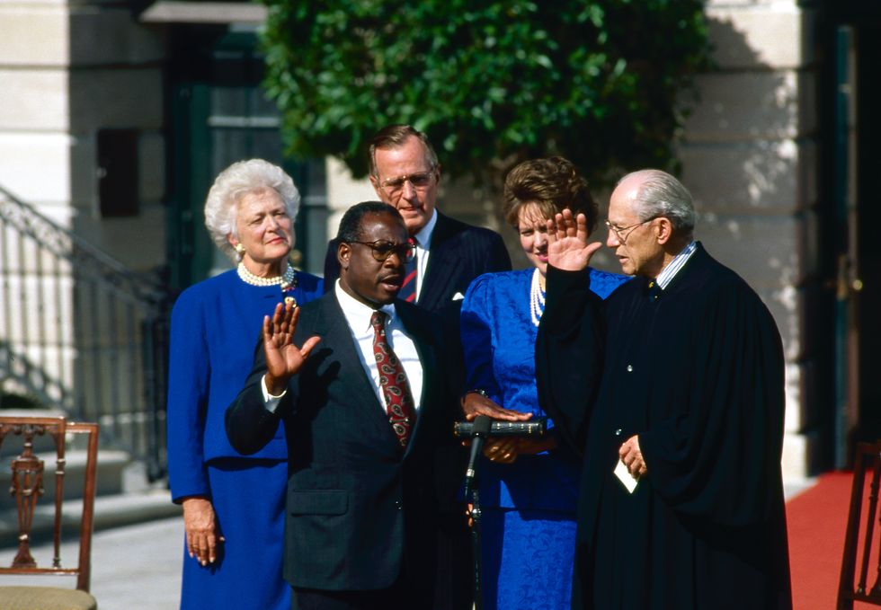 washington, dc 10 18 1991 judge clarence thomas nominee for associate justice of the united states supreme court is sworn in by justice bryon white on the white house south lawn as his wife virginia and president hw bush and barbara bush look on credit mark reinstein photo by mark reinsteincorbis via getty images