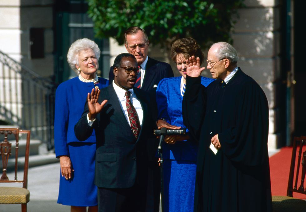 washington, dc 10 18 1991 judge clarence thomas nominee for associate justice of the united states supreme court is sworn in by justice bryon white on the white house south lawn as his wife virginia and president hw bush and barbara bush look on credit mark reinstein photo by mark reinsteincorbis via getty images