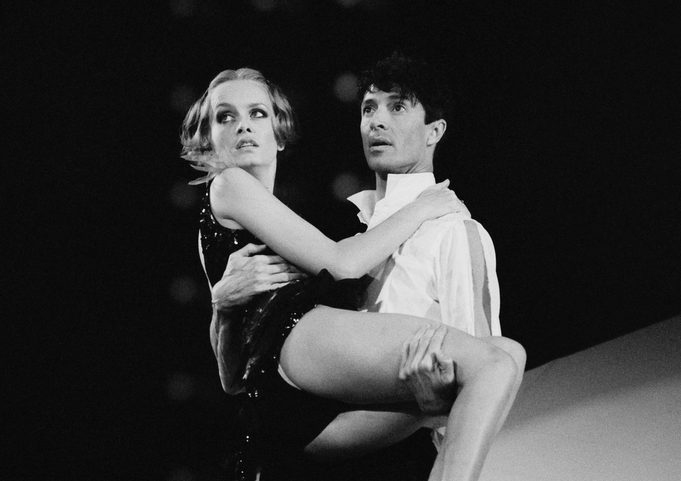 a couple performing a lift dance move on stage