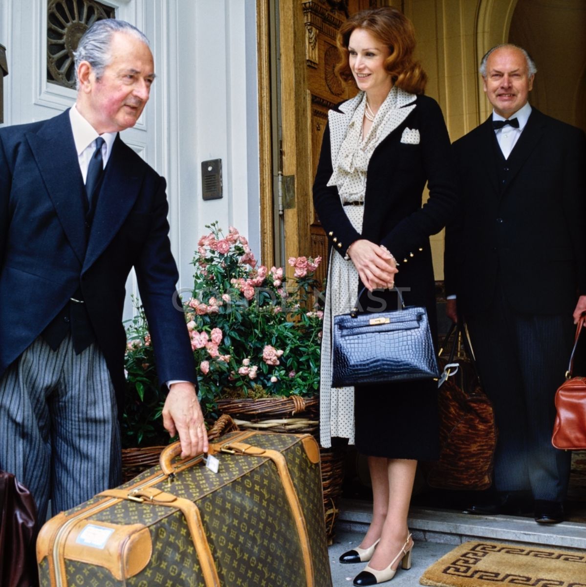 Ann Getty departing her mansion in San Francisco in 1977, aided by footman Frank Parkes, Left, and butler Francis Bullimore, photographed by Horst.