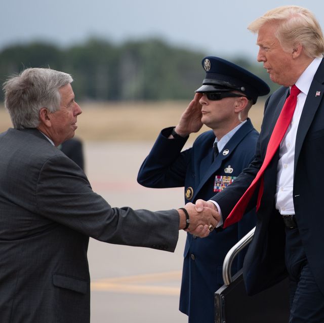 us president donald trump shakes hands with missouri governor mike parson l as he disembarks from air force one upon arrival at st louis lambert international airport in st louis, missouri, july 26, 2018, as he travels to nearby granite city, illinois to speak about the economy photo by saul loeb  afp        photo credit should read saul loebafp via getty images