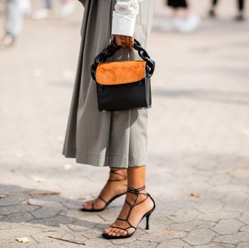 a woman at copenhagen fashion week wears strappy sandals to illustrate a guide to the best summer sandals 2024