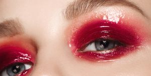 Beautiful woman with glossy red bright make-up