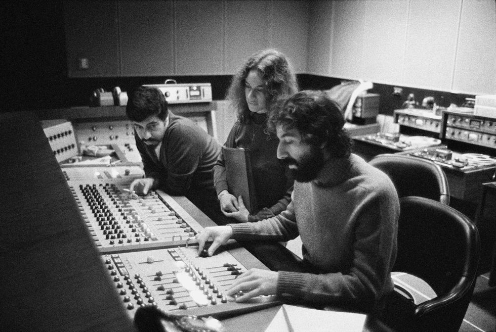 Recording engineer Hank Cicalo, singer-songwriter Carole King and record producer Lou Adler gather around the mixing desk in the control room of A&M Records Recording Studio in January 1971 during the recording of King's album 'Tapestry'