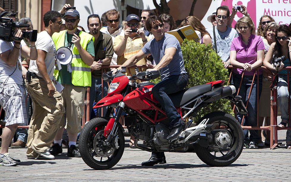 seville, spain   june 16  actor tom cruise rides a motorcycle for the official knight and day movie stunt exhibition prior the world premier tomorrow night, next to sevilles cathedral  on june 16, 2010 in seville, spain  photo by fernando caminogetty images
