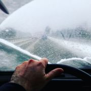 Cropped Image Of Man Driving Car During Winter