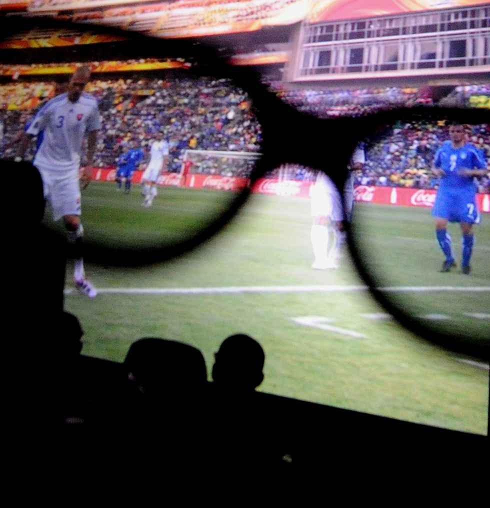 a view through 3d glasses during the football game between italy and slovakia in the south africa world cup at a cinema in central  rome on june 24, 2010 the four time world champions slumped 3 2 to a slovakia side that had been among the least impressive of the 32 at the tournament in south africa during their first two group gamesafp photo  tiziana fabi photo credit should read tiziana fabiafp via getty images