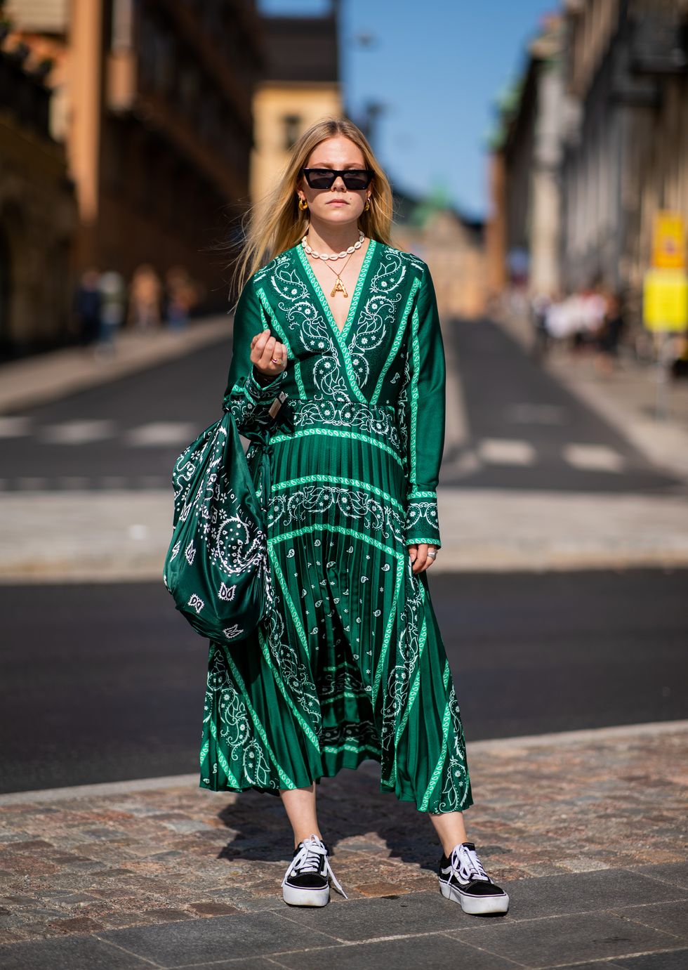 stockholm, sweden august 29 a guest wearing green dress and bag, vans is seen during stockholm runway ss19 on august 29, 2018 in stockholm, sweden photo by christian vieriggetty images
