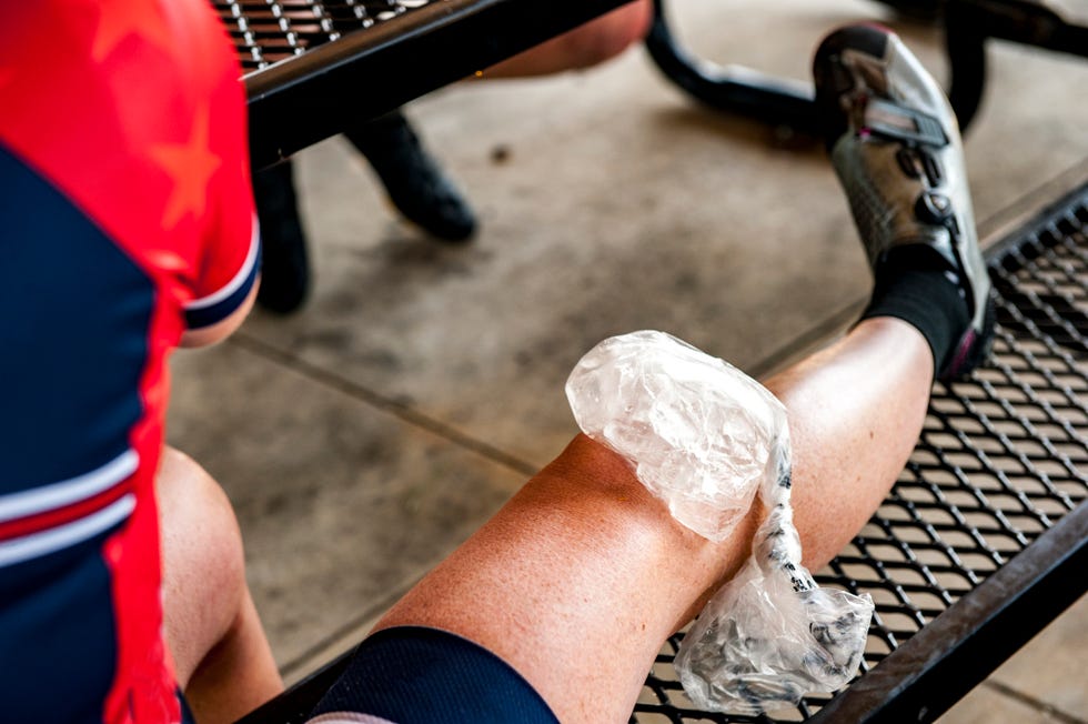 an ice pack on a womans knee during a break from a bike ride